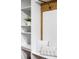 Mudroom featuring white shelving, bench seating with pillows, wood accents, and a plant at 1908 Taft Dr, Lakewood, CO 80215