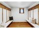 Mudroom with bench seating, overhead hooks, wood accents, and a window for natural light at 1908 Taft Dr, Lakewood, CO 80215