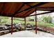 Outdoor patio with stone features, overhead lighting, and a view of the green backyard at 1908 Taft Dr, Lakewood, CO 80215