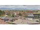 An aerial shot shows the location and the surrounding neighborhood in front of the mountains at 1655 Wolff St, Denver, CO 80204