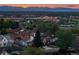 Aerial neighborhood shot showcases home location near local shopping areas, mountains, and beautiful sunset at 1655 Wolff St, Denver, CO 80204
