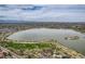 Scenic aerial view of a lake with walking paths and lush green space around the perimeter at 1655 Wolff St, Denver, CO 80204