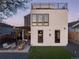 Home featuring a backyard with artificial grass and an outdoor seating area at 1655 Wolff St, Denver, CO 80204