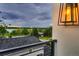 Balcony featuring lake view, and modern exterior lighting fixture at 1655 Wolff St, Denver, CO 80204