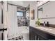 Modern bathroom featuring tiled shower, contemporary fixtures, and patterned tile floors at 1655 Wolff St, Denver, CO 80204