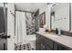 Bathroom with a patterned floor, shower with curtain, and vanity at 1655 Wolff St, Denver, CO 80204