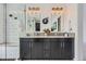 Bright bathroom featuring double vanity with modern fixtures and geometric floor tiles at 1655 Wolff St, Denver, CO 80204