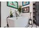 Bright bathroom with modern tub, floating shelves, trendy decorations and geometric floor at 1655 Wolff St, Denver, CO 80204