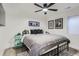 Bedroom featuring a black metal bed frame, gray comforter and stylish decor at 1655 Wolff St, Denver, CO 80204