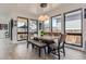 Bright dining area featuring a modern table with a bench, surrounded by large windows and natural light at 1655 Wolff St, Denver, CO 80204