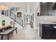 Bright entryway features hardwood floors, modern black staircase, and leads into the adjacent kitchen at 1655 Wolff St, Denver, CO 80204