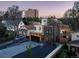Modern home exterior featuring mixed materials, a balcony, and spacious driveway, with neighborhood view at 1655 Wolff St, Denver, CO 80204