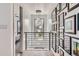 Bright hallway with stylish lighting fixtures, modern railings, and gallery wall at 1655 Wolff St, Denver, CO 80204