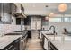 Modern kitchen featuring stainless steel appliances, sleek black cabinets, and stunning marble countertops at 1655 Wolff St, Denver, CO 80204