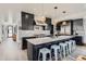 Modern kitchen featuring dark cabinets, a marble island, and stainless steel appliances at 1655 Wolff St, Denver, CO 80204