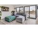 Comfortable living room with stylish sectional sofa, ottoman, and sliding glass doors to deck at 1655 Wolff St, Denver, CO 80204