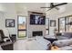 Modern living room featuring a fireplace, large TV, stylish furniture, and bright natural light at 1655 Wolff St, Denver, CO 80204