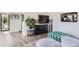 Open living room with a modern wet bar, hardwood floors, and abundant natural light at 1655 Wolff St, Denver, CO 80204