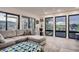 Living room boasting large windows with scenic views, gray sofa, and modern decor at 1655 Wolff St, Denver, CO 80204