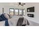 Bright main bedroom with large windows, mounted TV, and scenic neighborhood views at 1655 Wolff St, Denver, CO 80204
