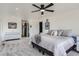 Bright main bedroom with a modern bed, a light grey carpet, white walls, and contemporary decor at 1655 Wolff St, Denver, CO 80204