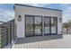Stylish outdoor deck featuring sliding glass doors, sleek railing, and modern outdoor lighting at 1655 Wolff St, Denver, CO 80204