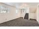 Spacious basement Gathering room with neutral carpeting and staircase at 16046 E Harvard Ave, Aurora, CO 80013