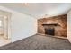 Finished basement with a brick fireplace and neutral carpeting at 16046 E Harvard Ave, Aurora, CO 80013