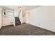 Finished basement with neutral carpeting and staircase at 16046 E Harvard Ave, Aurora, CO 80013