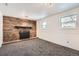 Finished basement recreation room featuring a brick fireplace at 16046 E Harvard Ave, Aurora, CO 80013