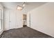 Well-lit bedroom with grey carpet and access to hallway at 16046 E Harvard Ave, Aurora, CO 80013