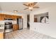 Kitchen boasts stainless steel appliances, wood cabinets, and granite countertops at 16046 E Harvard Ave, Aurora, CO 80013