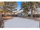 Backyard with shed, trees and snow on the ground at 440 S York St, Denver, CO 80209