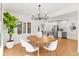 Open concept dining room with modern light fixture and kitchen view at 440 S York St, Denver, CO 80209