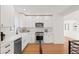 Modern white kitchen with stainless steel appliances and quartz countertops at 440 S York St, Denver, CO 80209