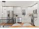 Modern white kitchen with stainless steel appliances and farmhouse sink at 440 S York St, Denver, CO 80209