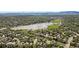Overhead neighborhood shot displaying lake, mature landscaping, and stunning mountain backdrop at 8305 Eaton Way, Arvada, CO 80003