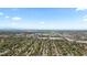 Expansive aerial view of the suburban neighborhood with mature trees and distant cityscape at 8305 Eaton Way, Arvada, CO 80003