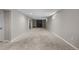 Unfurnished basement showcasing a fireplace with grey brick and neutral carpeting at 8305 Eaton Way, Arvada, CO 80003