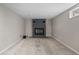 Unfurnished basement showcasing a fireplace with grey brick and neutral carpeting at 8305 Eaton Way, Arvada, CO 80003
