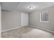 Unfurnished basement with neutral carpeting, a window, and a white closet at 8305 Eaton Way, Arvada, CO 80003