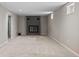 Spacious basement with neutral carpet, a brick fireplace, and lots of natural light at 8305 Eaton Way, Arvada, CO 80003