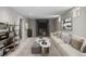 Staged basement with modern decor, a fireplace, and a white sofa at 8305 Eaton Way, Arvada, CO 80003