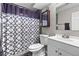Bathroom with white vanity, toilet and a shower with a patterned curtain at 8305 Eaton Way, Arvada, CO 80003