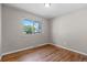 Cozy bedroom featuring hardwood floors and a bright window view at 8305 Eaton Way, Arvada, CO 80003