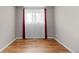 Bedroom with hardwood flooring and a window with red curtains at 8305 Eaton Way, Arvada, CO 80003