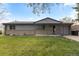 Well-maintained single-story house with a covered porch and lush green lawn in a quiet neighborhood at 8305 Eaton Way, Arvada, CO 80003