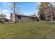 Charming single-story home with a well-manicured lawn, and mature trees at 8305 Eaton Way, Arvada, CO 80003