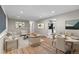 Staged living room with hardwood floors and dining area adjacent to the kitchen at 8305 Eaton Way, Arvada, CO 80003