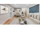 Staged open-concept living area with hardwood floors, kitchen and dining room view at 8305 Eaton Way, Arvada, CO 80003
